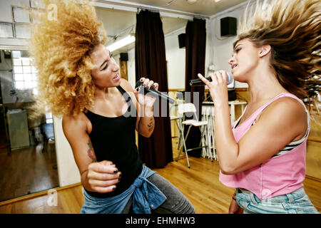 Singers rehearsing in studio Stock Photo