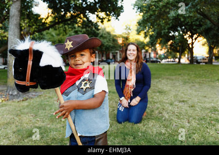Mother with son dressed as cowboy for Halloween Stock Photo