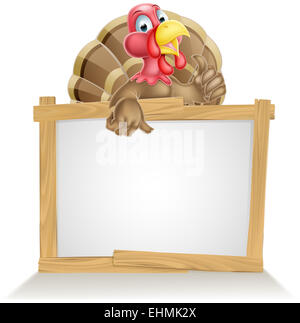 Cartoon turkey bird sign with cartoon turkey bird pointing at sign and giving a thumbs up Stock Photo