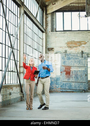 Business people using digital tablet in warehouse Stock Photo