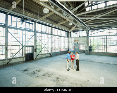 Business people talking in empty warehouse Stock Photo