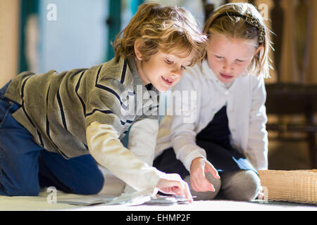 Children working together on floor in classroom Stock Photo