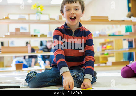 Caucasian boy playing in classroom Stock Photo