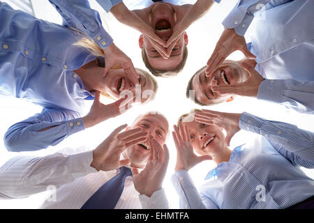 smiling group of businesspeople standing in circle Stock Photo