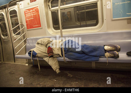 Homeless man sleeping on a New York City subway train Stock Photo - Alamy