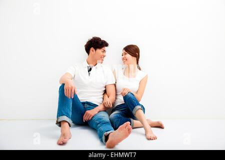 Happy Young asian Couple Sitting On Floor Stock Photo