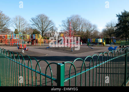 Colourful children's empty playground with lots of fun equipment including a spiders web climbing frame Stock Photo