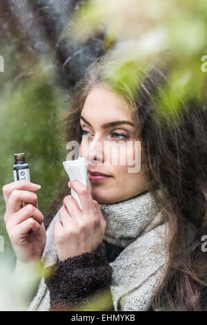 Woman smelling essential oil. Stock Photo
