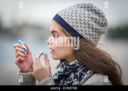 Woman taking homeopathic medicine. Stock Photo