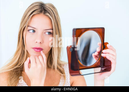 Young woman with finger on lips. Stock Photo