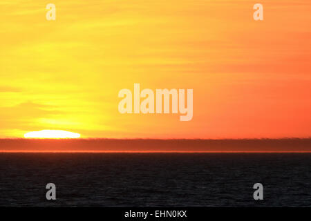 Sunset sky with sun colorful orange yellow sky landscape. Stock Photo