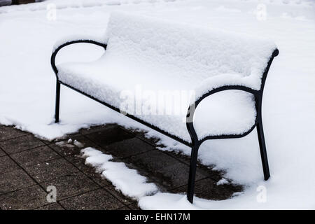 Bench covered in snow. Stock Photo