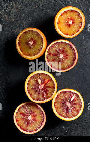 halved blood orange on black background Stock Photo
