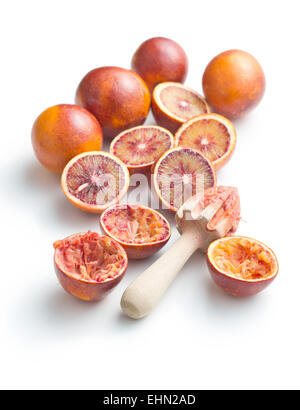 halved blood orange and juicer on white background Stock Photo