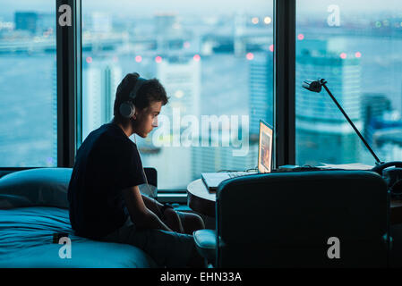 Teenage boy using a laptop. Stock Photo