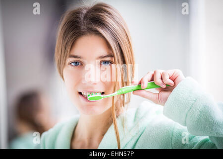Woman brushing her teeth with toothbrush. Stock Photo