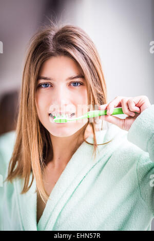 Woman brushing her teeth with toothbrush. Stock Photo