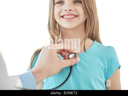 close up of happy girl and doctor on medical exam Stock Photo