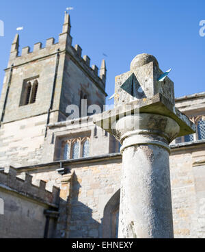 St Peter's church at Coughton Court near Alcester in the West Midlands with its ancient sundial in the churchyard Stock Photo