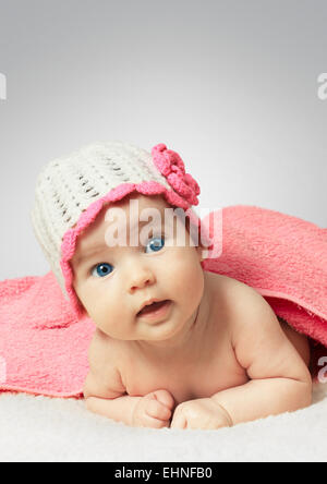 Funny newborn little baby wearing a hat with towel Stock Photo