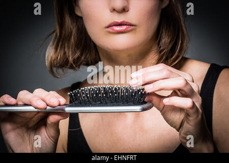 Woman brushing her hair. Stock Photo