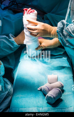 Laying a bandage after hand surgery. Stock Photo