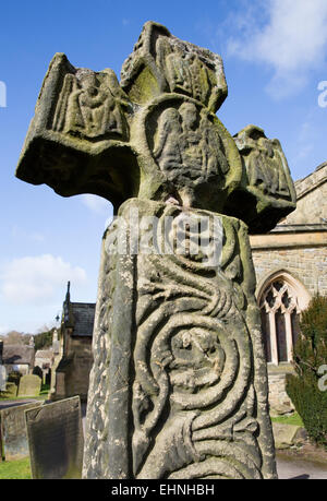 The 8th century Anglo Saxon or Celtic Cross in St Lawrence's churchyard at Eyam in the Derbyshire Peak District Stock Photo