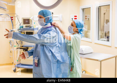 Surgical team getting dressed before surgery, Limoges hospital, France Stock Photo