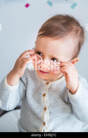 An 18 month old boy wearing lederhosen makes a funny face Stock Photo