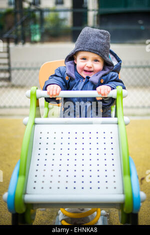 18 month-old baby boy in a playground. Stock Photo