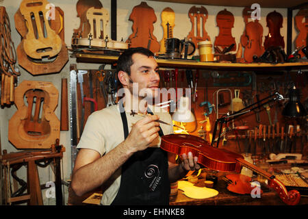 Violin maker Stefano Conio in his workshop in Cremona, Italy. Stock Photo