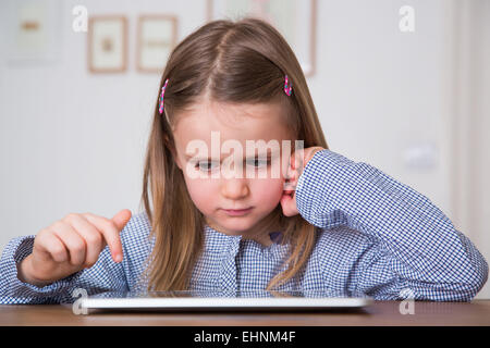 5 year-old girl using tablet computer. Stock Photo