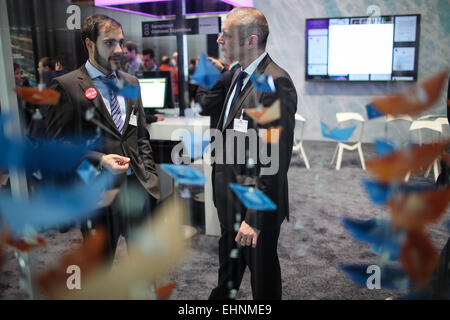 Hanover, Germany. 16th Mar, 2015. Two staff members talk at the IBM's stand at 2015 CeBIT Technology Trade fair in Hanover, Germany, on March 16, 2015. Top IT business fair CeBIT 2015, which features a strong Chinese presence, opened on Sunday in Germany. Credit:  Zhang Fan/Xinhua/Alamy Live News Stock Photo