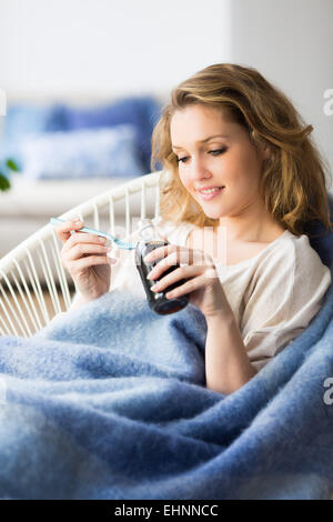 Woman taking syrop. Stock Photo