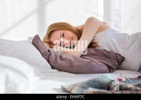 Woman resting bed. Stock Photo