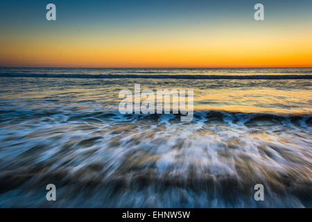 Sunset over waves in the Pacific Ocean, in Santa Monica, California. Stock Photo