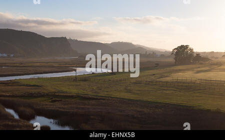 Beautiful morning view the over sleepy fields and river of a a horse stable and the mountains at Plettenburg Bay, South Africa