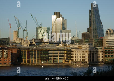 Evening view of buildings, cranes and construction on the north bank of the Thames opposite Tate Modern Art Gallery in London Stock Photo