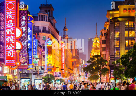 Neon signs lit on Nanjing Road in Shanghai, China. Stock Photo