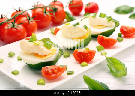 Easter eggs with mayonnaise and spring onions and cherry tomatoes Stock Photo