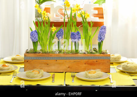 Easter table decorated with spring flowers Stock Photo