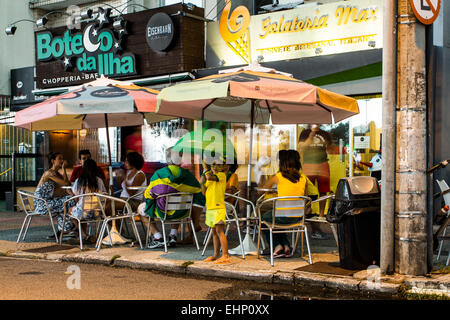 People sitting at snack bar tables on the sidewalk of Beira Mar Norte Avenue. Florianopolis, Santa Catarina, Brazil. Stock Photo