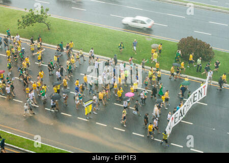 Protesters walk on Beira Mar Norte Avenue under heavy rain in the manifestation for the impeachment of Brazilian president. Stock Photo