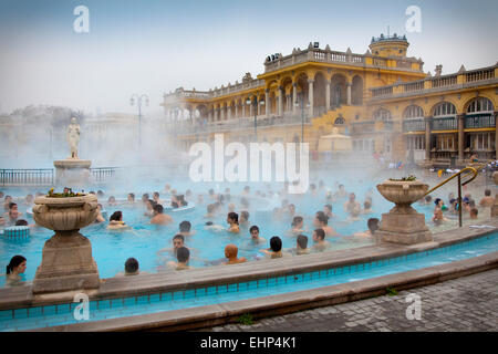 Tourists and locals enjoy the Széchenyi Thermal baths on a cold winter's day, Budapest, Hungary Stock Photo