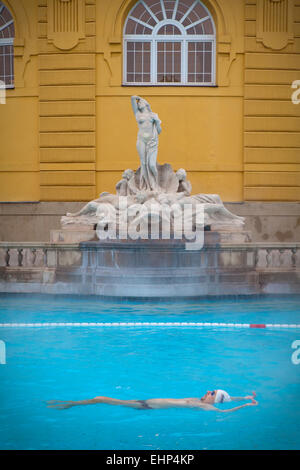 Tourists and locals enjoy the Széchenyi Thermal baths on a cold winter's day, Budapest, Hungary Stock Photo