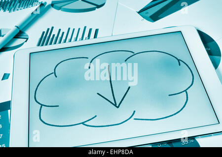 a drawing of a cloud with an arrow inside on the screen of a tablet, depicting the concept of download from the cloud storage Stock Photo
