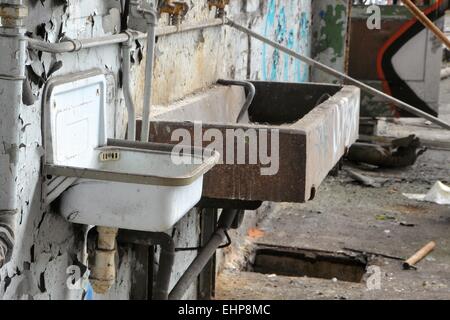 Washbasins in a disused factory Stock Photo