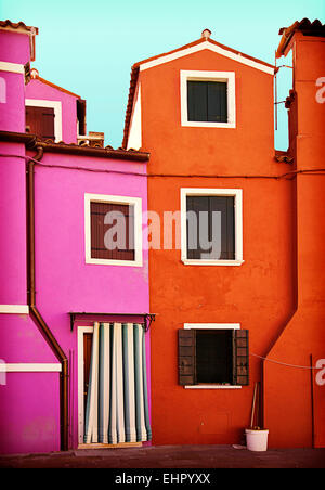 two houses painted in striking colors in Burano, small island near Venice Stock Photo
