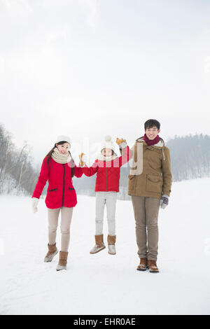 Happy family playing on the snow Stock Photo