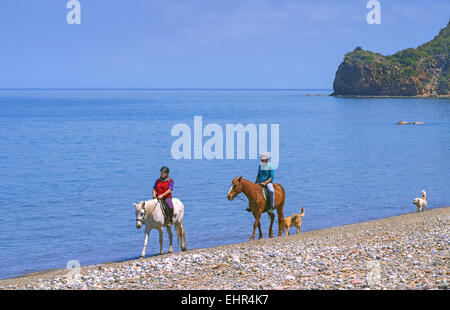 Horse riding at Psaropouli beach in the northeastern Evia, Aegean sea, Greece Stock Photo